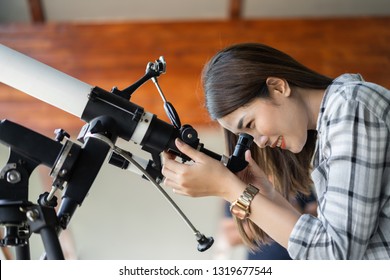 Woman Looking Through Binoculars Or Telescope