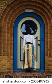 Woman Looking Through Cottage Window