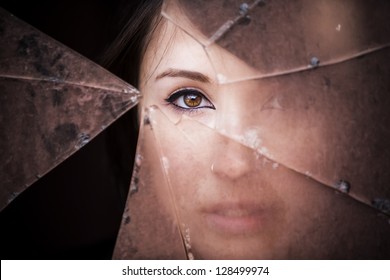 Woman Looking Through Dirty Broken Glass