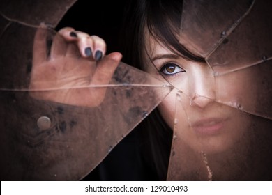 Woman Looking Through Dirty Broken Glass