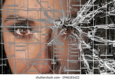 Woman Looking Through Dirty Broken Glassю Close Up Image. Calm Woman  Face With Opened Eyes Behind The Texture Of A Broken Glass