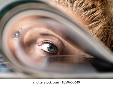 Woman Looking Through Folded Pages Of A Magazine, Green Eyes Woman. Student Or Professor Looking Through Papers
