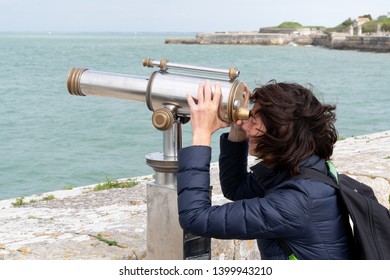 Woman Looking Through Telescope At Beach In Island Ile De Re In France