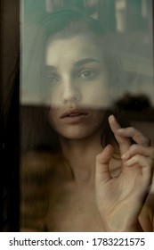 Woman Looking Through A Window