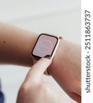 Woman looking at the time on her digital smartwatch