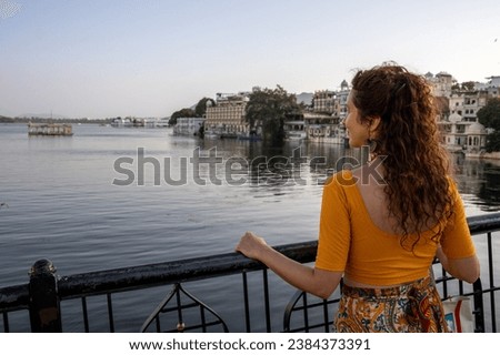Woman looking towards Lake Pichola in Udaipur in Rajasthan in India.