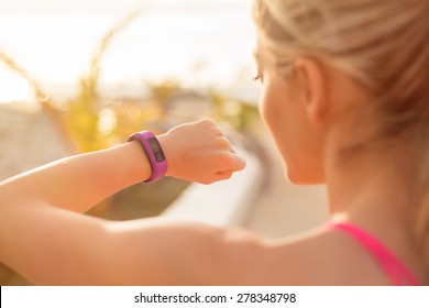 Woman Looking At Wearable Fitness Device