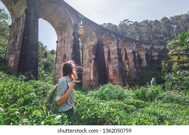 Woman looks at the Demodara nine arches bridge the most visited sight of Ella town in Sri Lanka, Travel to Asia