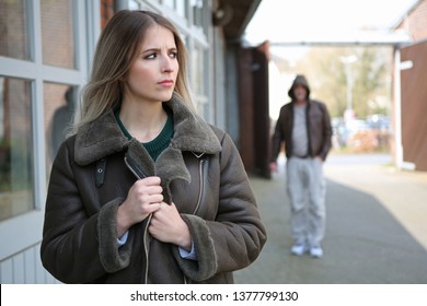 Woman Looks Frightened Because A Stalker Follows Her