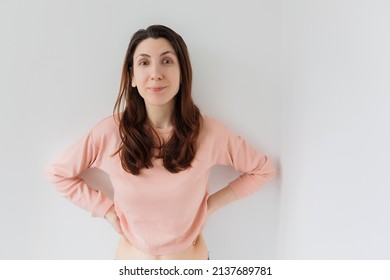 Woman Looks With A Happy Expression On His Face And Does Not Believe What He Saw Looking At Camera Isolated On Light Gray Background