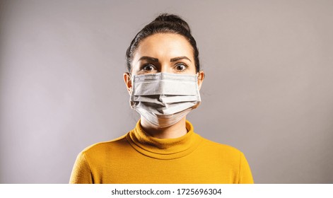 Woman looks scared wearing protection face mask against coronavirus outbreak COVID-19.  - Shutterstock ID 1725696304
