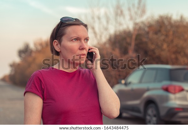 Woman lost\
during car driving through countryside talking on mobile phone\
trying to get help and roadside\
assistance