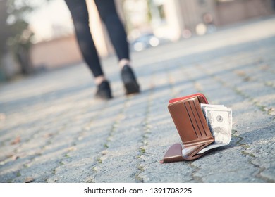 Woman lost a leather wallet with money on the park. - Shutterstock ID 1391708225