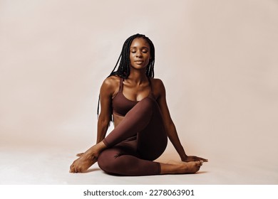 woman in lotus pose yoga studio portrait - Powered by Shutterstock
