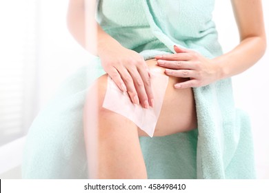 Woman Lubricates The Feet With A Handkerchief Self Tanning. Female Nurses Legs In The Shower, Rubbing Lotion On Handkerchiefs 