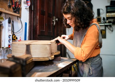 Woman Luthier Making Guitars In Her Musical Instrument Workshop