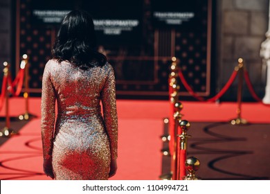 Woman in a luxurious dress on a red carpet