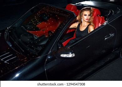 Woman In Luxury Car. Night Life.
