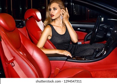 Woman In Luxury Car. Night Life.