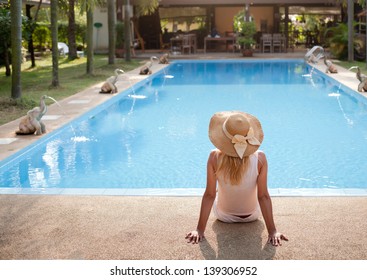 Woman In Luxury Spa Resort Near The Swimming Pool