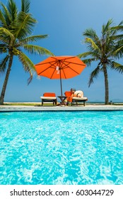 Woman In Luxury Spa Resort Near The Swimming Pool. 