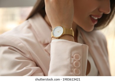 Woman With Luxury Wristwatch On Blurred Background, Closeup