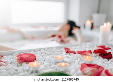 Woman Lying In Bath, Rose Petals, Burning Candles