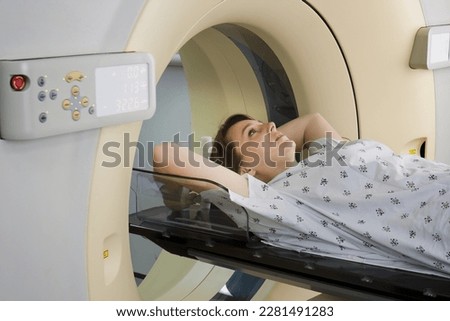 Woman lying down for a CAT scan for Breast Cancer diagnosis