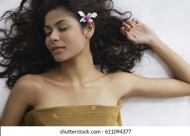 A Woman Lying Down With Flowers In Her Hair