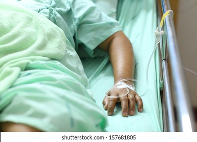 Woman Lying Down In Hospital Bed