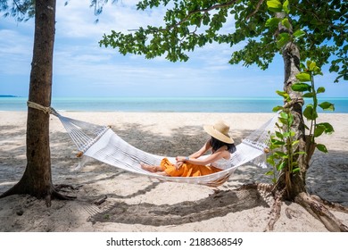 Woman Lying Down Relaxing On Hammock On The Beach