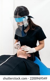 Woman Lying Down In Stretcher While Receiving Botulinum Toxin Injection In Beauty Clinic.