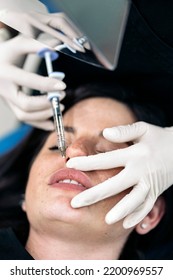 Woman Lying Down In Stretcher While Receiving Botulinum Toxin Injection In Beauty Clinic.