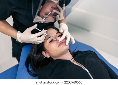 Woman Lying Down In Stretcher While Receiving Botulinum Toxin Injection In Beauty Clinic.