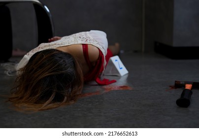 Woman Lying Face Down,hands Being Tied With Ropes, A Victim Woman Head Injury And Bleeding Blood Lying On Floor At Scene Area (it's An Acting),marked Sign Witness Object Bloody Hammer, Selective Focus