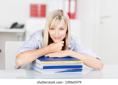 Woman lying her chin on the stack of books - Powered by Shutterstock