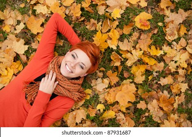 Woman Lying On Autumn Leaves, Outdoor Portrait