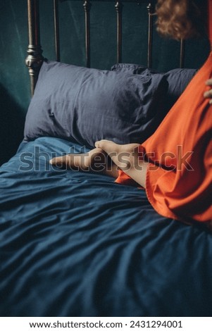 woman lying on bed in bedroom