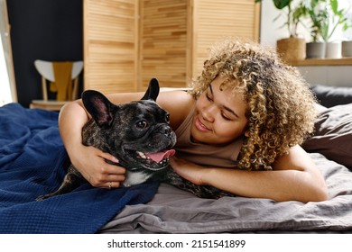 Woman Lying On Bed With Her Pet