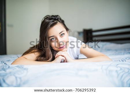 A woman lying on the bed and smiling