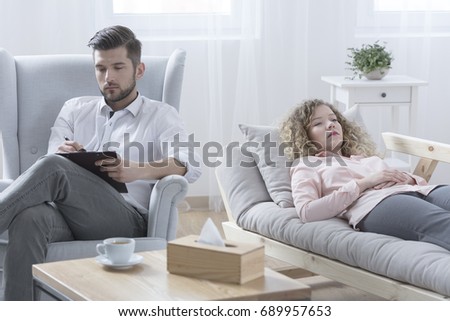 Woman lying on the couch at psychoanalyst's office