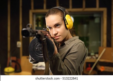 A woman with a machine gun. The woman at the shooting range shot from a rifle.