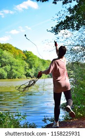 A Woman Magnet Fishing In A Dam