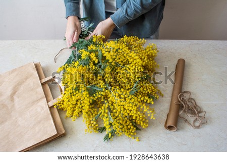 Woman make a bouquet of yellow spring flowers. Mother's day, Valentine's day, international women's day, March 8
