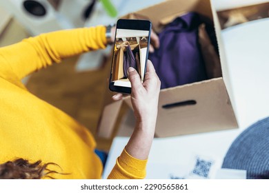 Woman make photo of cardboard box for storage. Concept organization, efficiency, or technology in storage management.