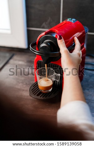 woman makes coffee in the morning