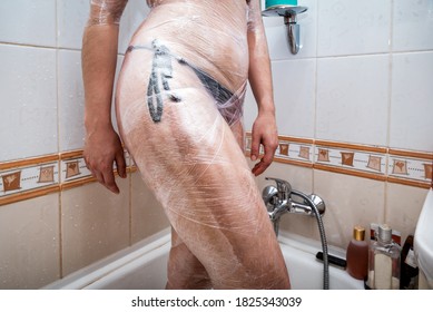 Woman Makes Cosmetic Body Wrap With Cellophane Tape. Spa Procedures