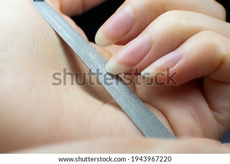 Similar – Woman filing nails in colored background