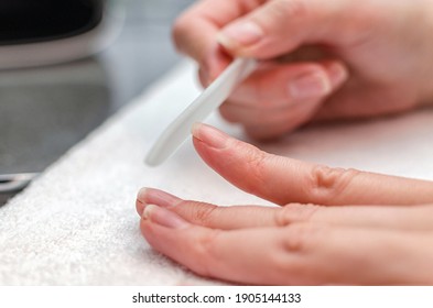 Woman Makes Herself A Manicure With A Nail File At Home