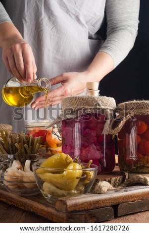 Woman makes homemade canned pickled and fermented vegetables for long-term storage. Preservation of seasonal vegetables and vitamins. Vegetarian food.
